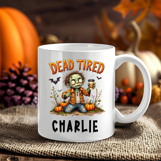 Personalised Dead Tired Coffee Zombie Halloween 11oz mug showing a coffee-loving tired zombie among Halloween pumpkins