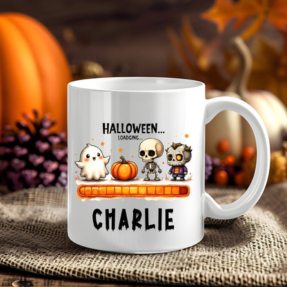 Personalised Halloween Loading Characters Halloween 11oz mug showing a ghost, jack-o'-lantern and spooky characters above an orange loading bar