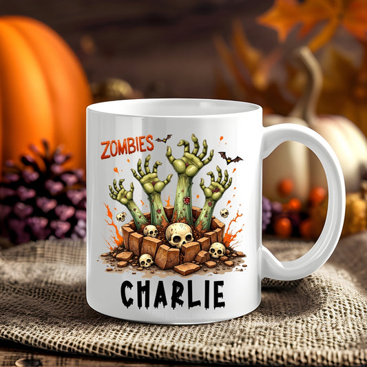 Personalised Zombies Halloween 11oz mug showing zombie hands reaching from a rocky grave surrounded by skulls