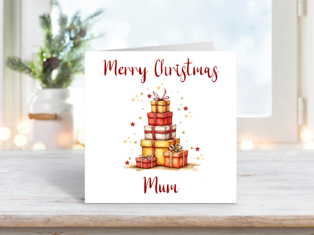 Christmas card featuring a tall pile of red and gold presents surrounded by small gold and red stars with the text “Merry Christmas Mum.”