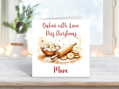 Christmas card featuring a bowl of biscuits, a rolling pin, and baked treats surrounded by stars, with the words “Baked with Love This Christmas Mum.”