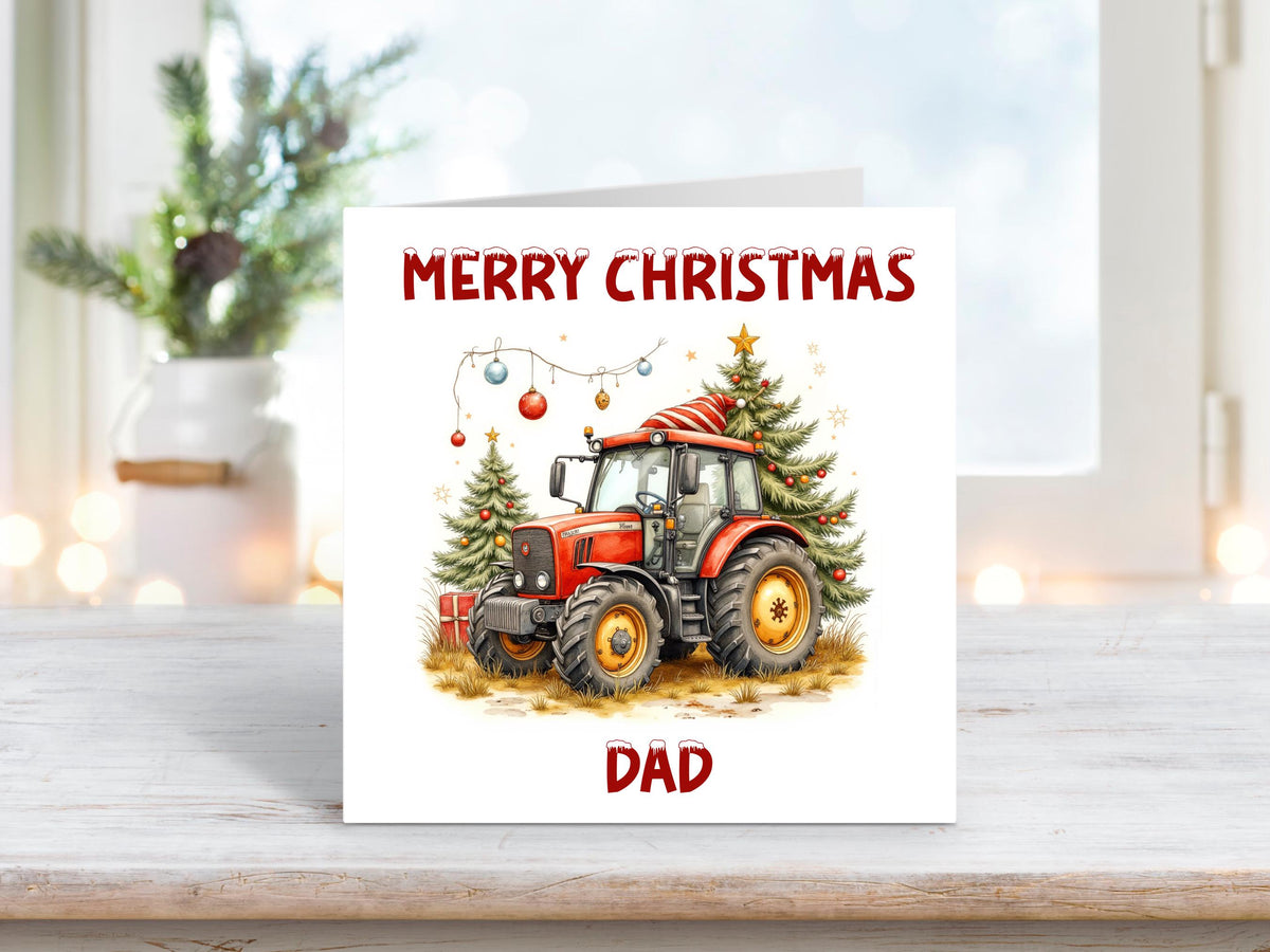 Personalised Christmas card featuring a red tractor wearing a Santa hat, parked beside two decorated Christmas trees with baubles, and the text “Merry Christmas Dad” in festive red lettering.