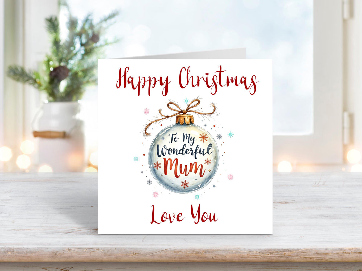 Christmas card featuring a silver bauble tied with twine, decorated with stars and snowflakes, and the words “To My Wonderful Mum – Happy Christmas Love You.”
