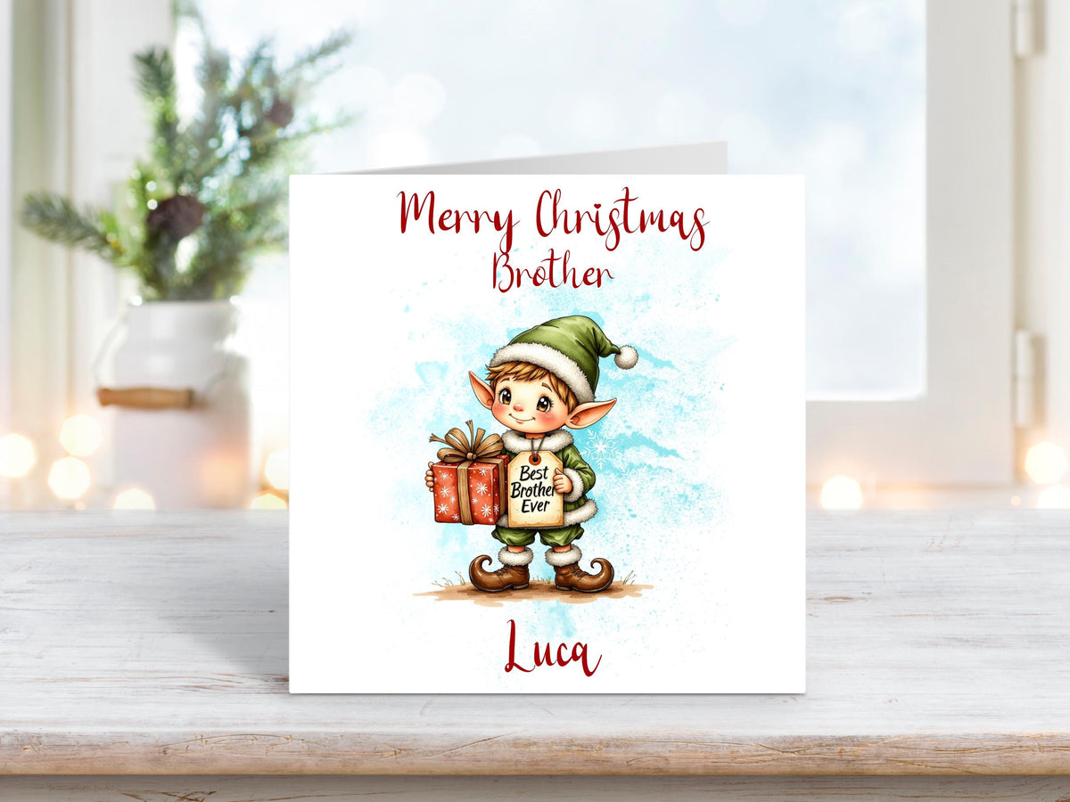 Cartoon Christmas card featuring a cheerful elf in green holding a present labelled “Best Brother Ever”, with “Merry Christmas Brother” and personalised name “Luca”.