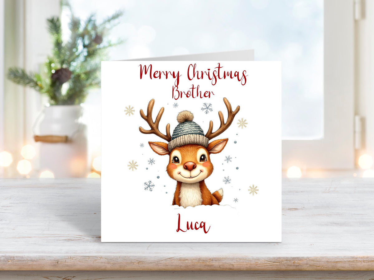Christmas card featuring a smiling reindeer wearing a knitted hat, with snowflakes and “Merry Christmas Brother” text above, personalised with the name Luca.