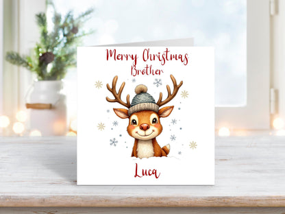 Christmas card featuring a smiling reindeer wearing a knitted hat, with snowflakes and “Merry Christmas Brother” text above, personalised with the name Luca.