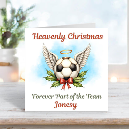 Memorial Christmas card showing a football with angel wings and a golden halo above holly and ribbon, with the words “Heavenly Christmas – Forever Part of the Team Jonesy.”