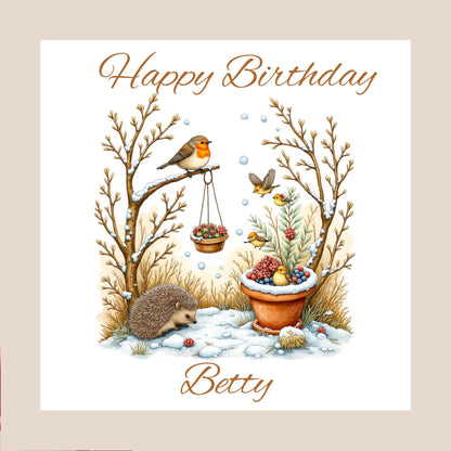 hand-drawn winter woodland scene with robin on a branch, hedgehog in snowy grass, potted berries and small birds — birthday card design