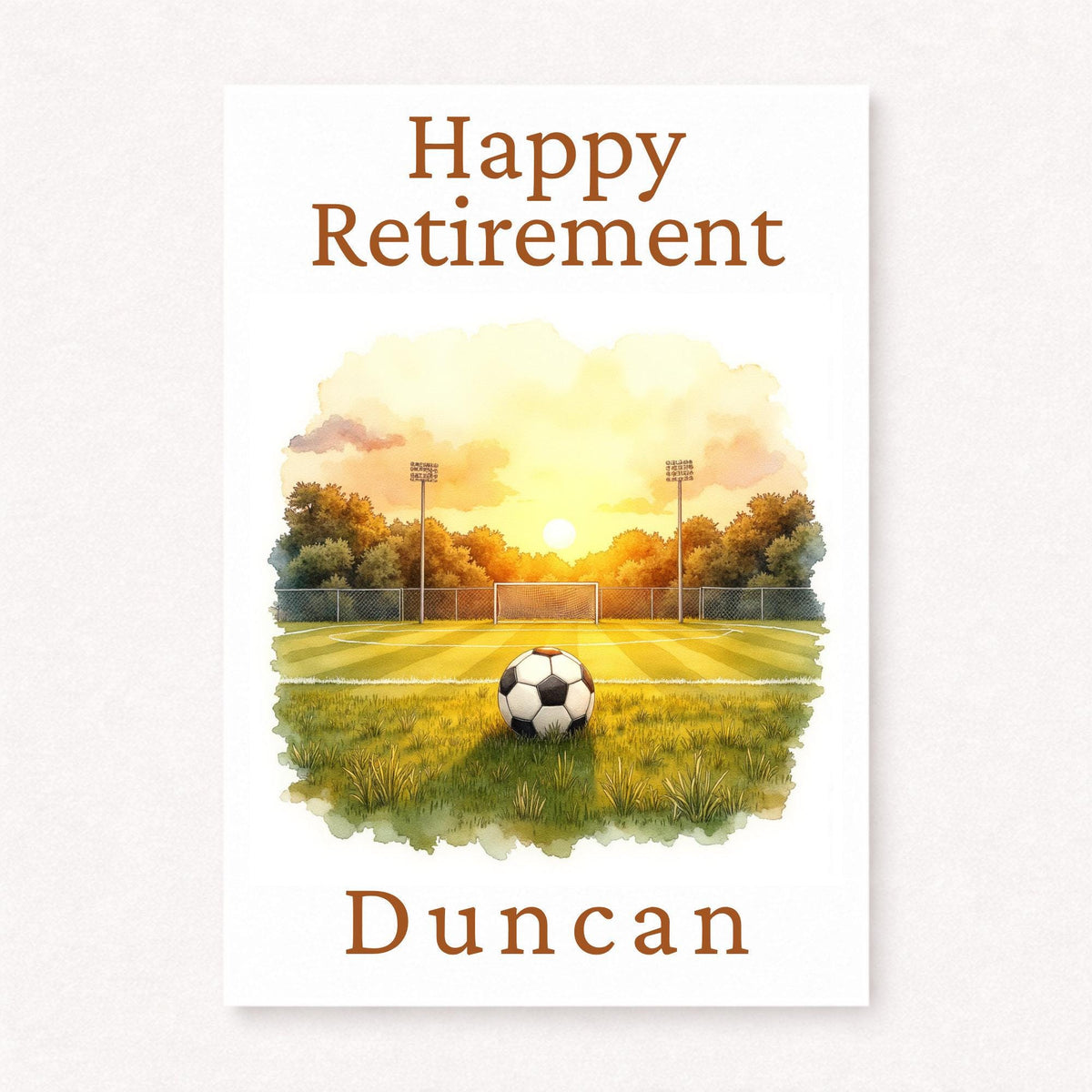 Personalised football retirement card with football on pitch at sunset, goal and stadium lights in background, happy retirement text and custom name