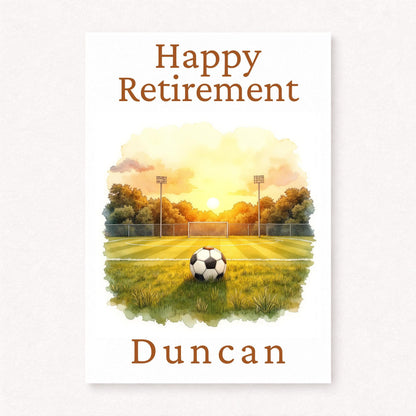 Personalised football retirement card with football on pitch at sunset, goal and stadium lights in background, happy retirement text and custom name