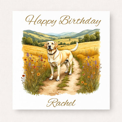 Birthday card with Labrador dog standing on countryside path with flowers and hills, personalised name design