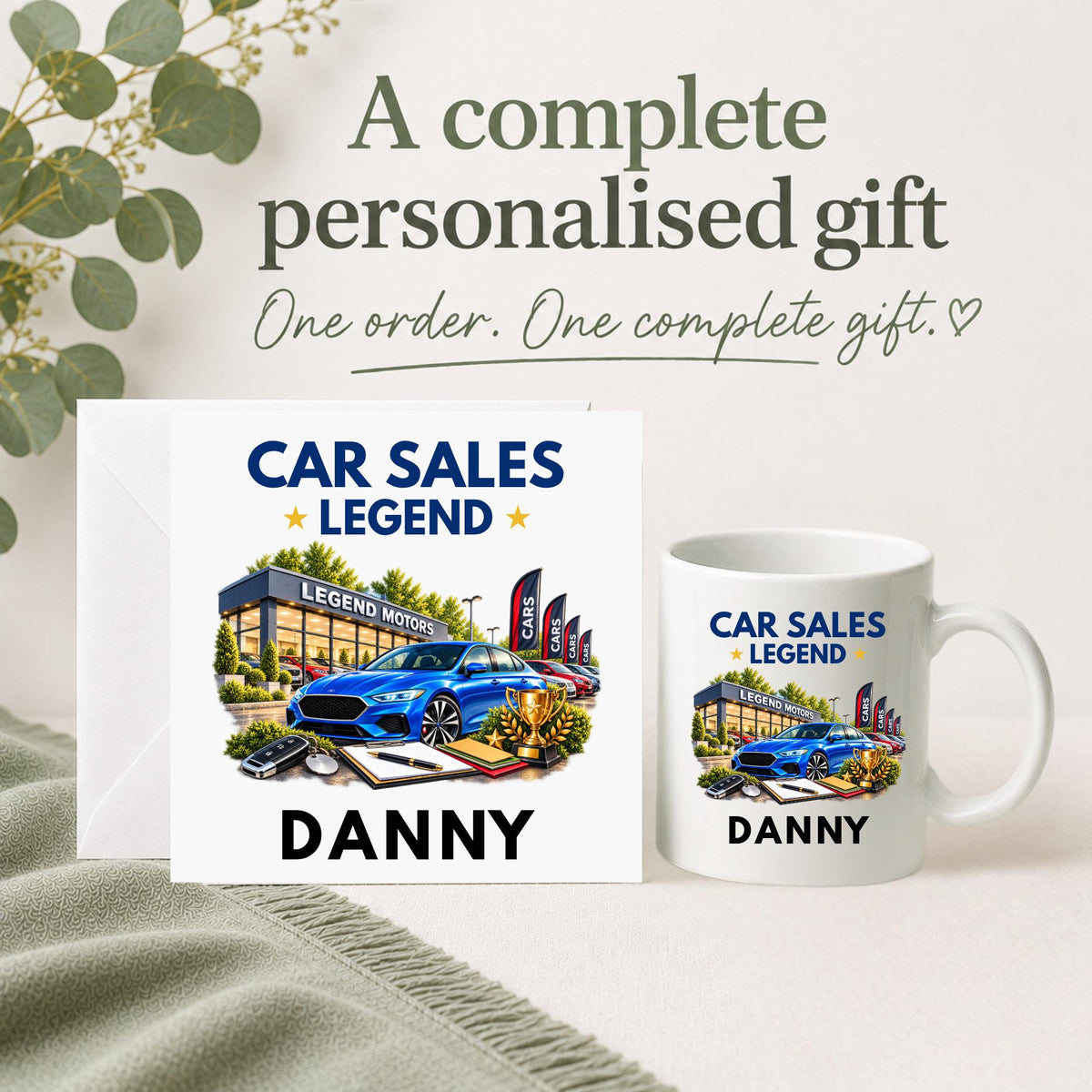 Personalised Car Sales Legend gift set with matching card and 11oz mug, featuring a car dealership, blue car, trophy and custom name.