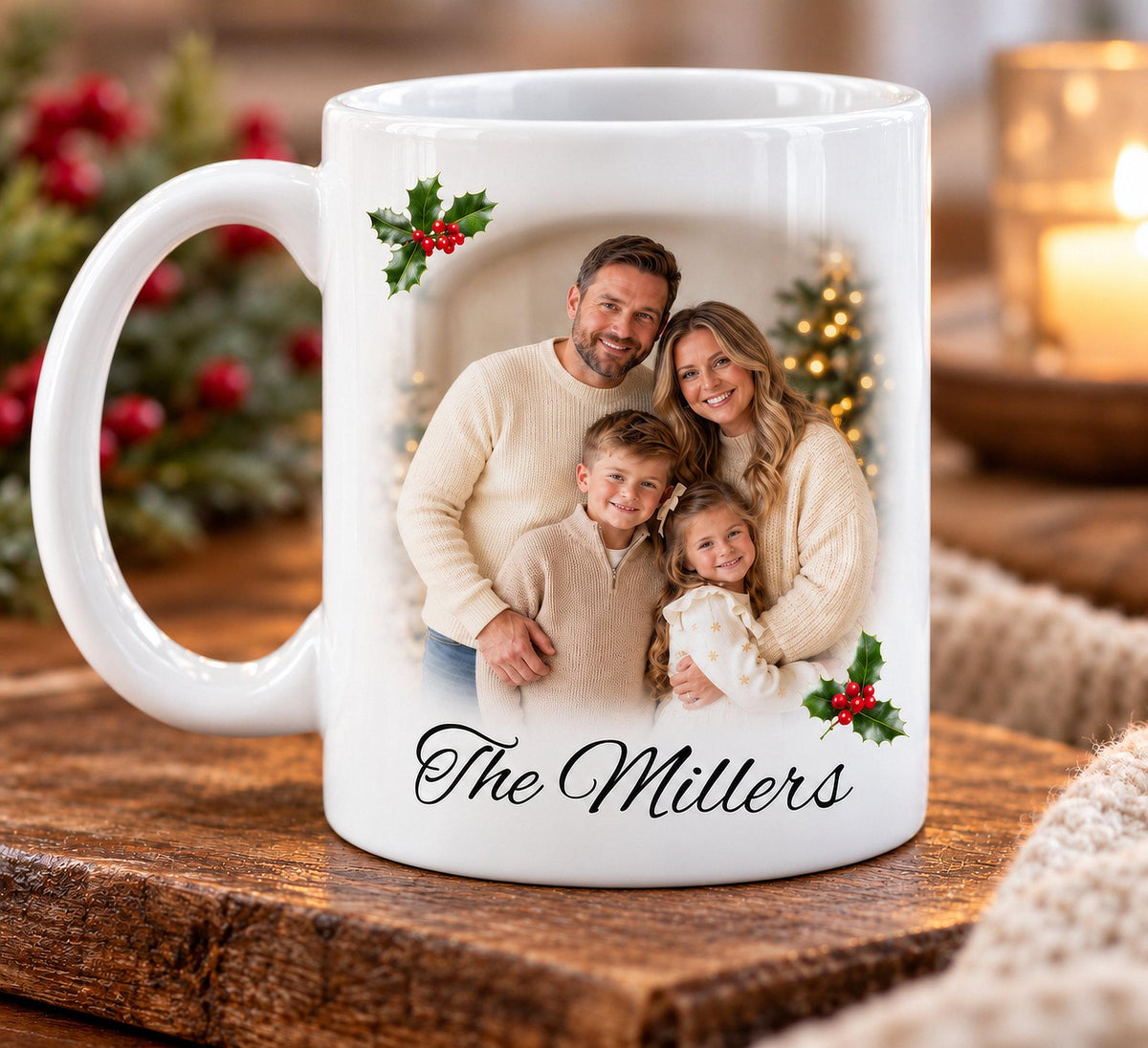 Personalised white ceramic Christmas photo mug featuring a smiling family of four, with their photograph softly faded into the mug's white surface. Crisp festive holly and red berry decorations frame the photograph, with the custom family name “The Millers” printed beneath in elegant black script. Displayed in a cosy Christmas setting.